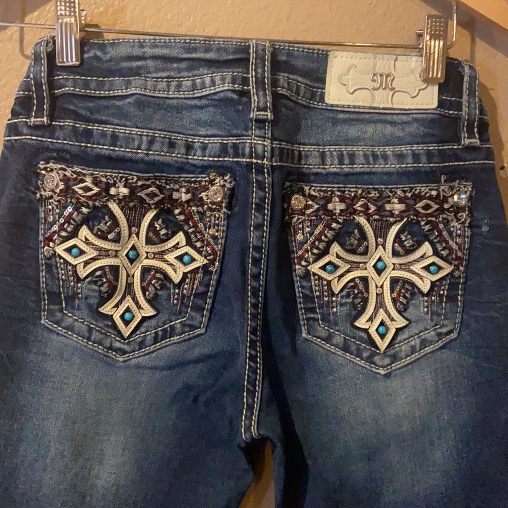 Miss Me jeans with red and turquoise embellishment on the pockets